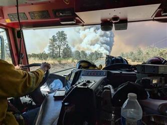 A firemans view driving towards the blaze.