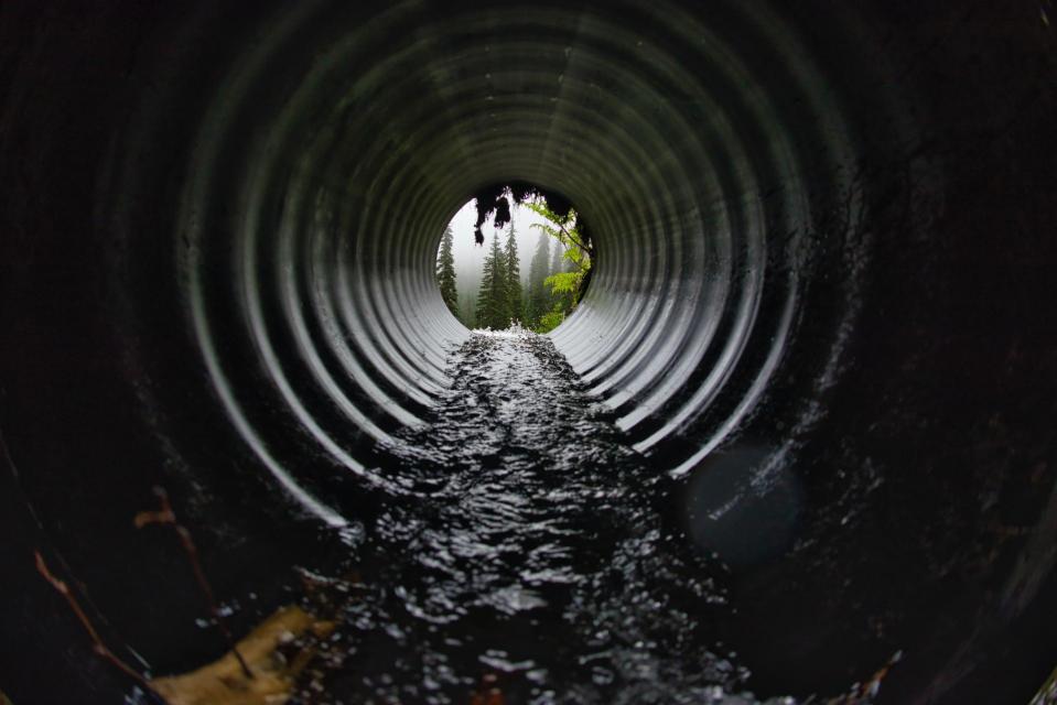 interior of sewer pipe with clear water running through it
