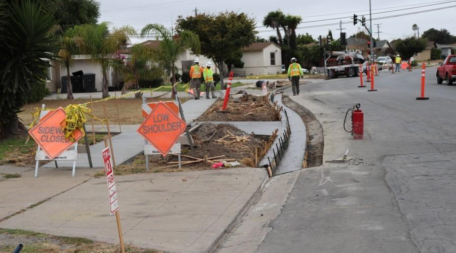 Road work signs blocking a sidewalk