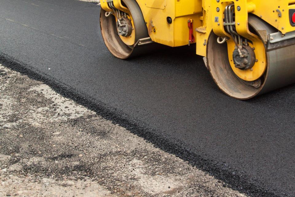 yellow road equipment paving new road
