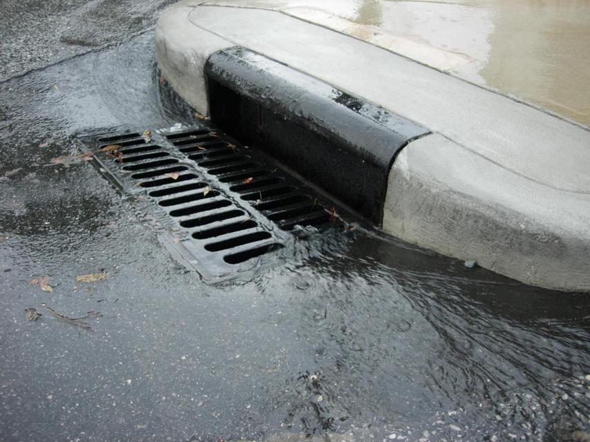 Storm drain at corner of sidewalk