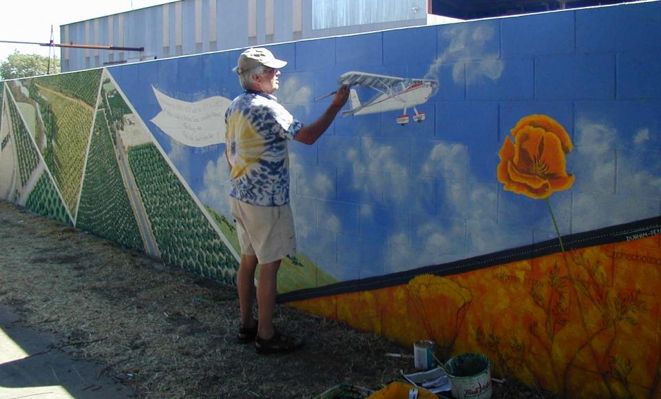 An artist working on his portion of the mural.